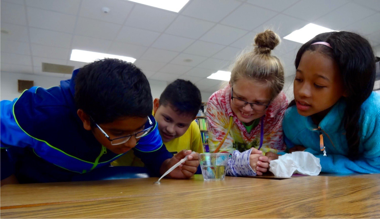 4 children in class doing science